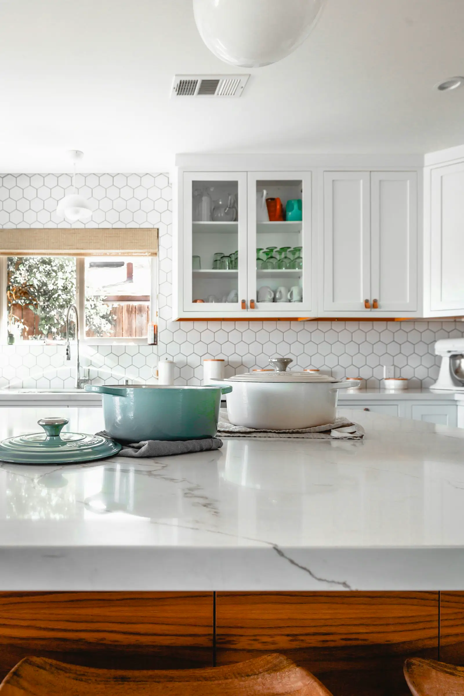 White kitchen cabinets, a marble island, and hex tile. Shown on the Keep layout page for Rockford, IL.
